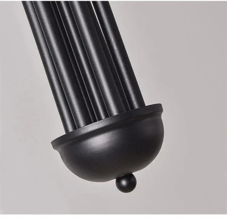 Nordic minimalist pendant light in black with a cluster of rods and a rounded bottom finial.