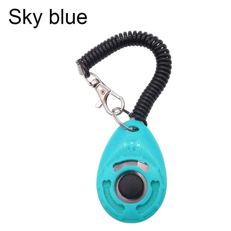 Adjustable dog training clicker in sky blue with black coiled wrist strap and keychain clip — Simples Market