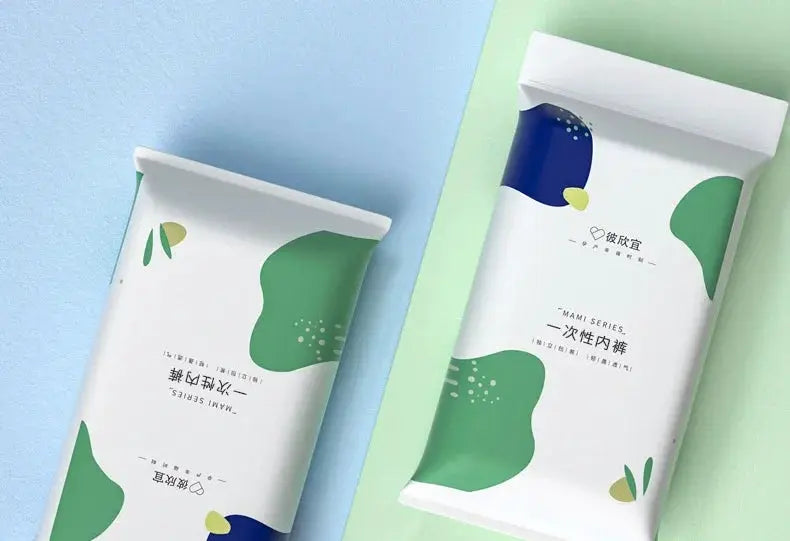 Disposable maternity panties by Simples Market, two white packages with green abstract shapes.