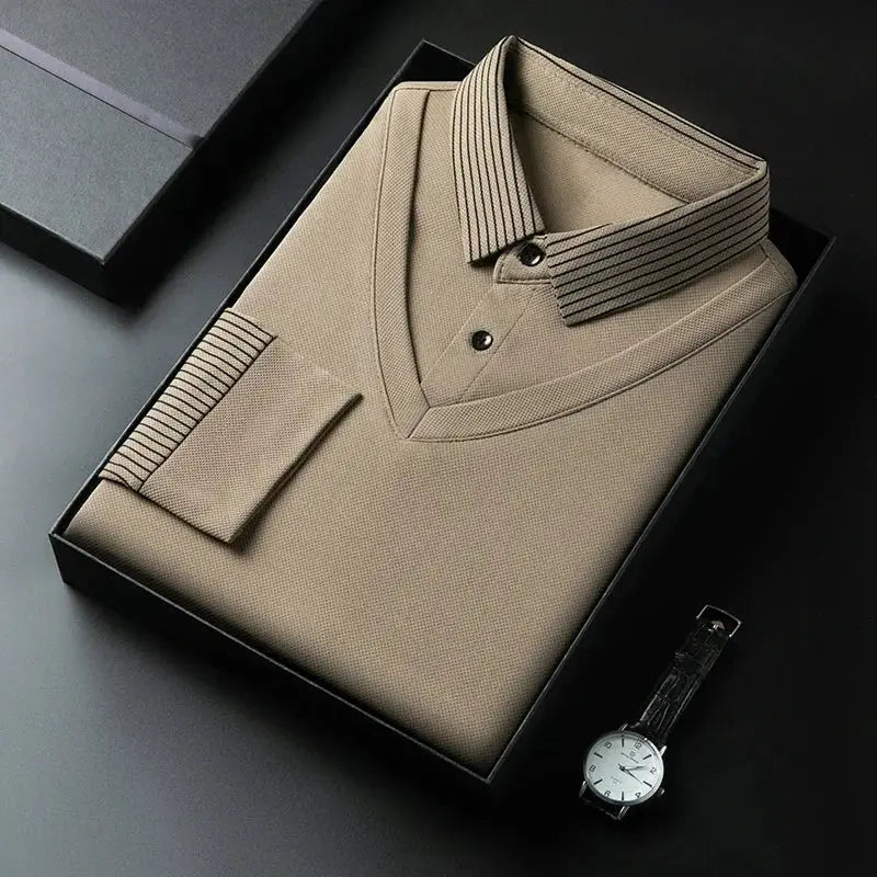 Men's long-sleeve polo shirt in beige, solid color, neatly folded in a black box with a wristwatch beside it