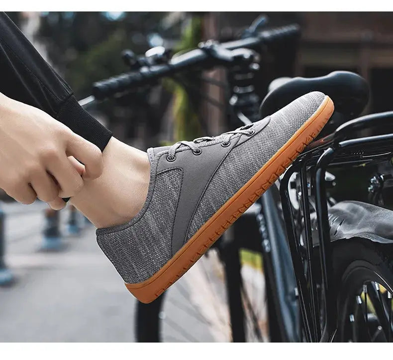 Simples Market men's minimalist trail running shoe, grey fabric upper with orange sole, wide width