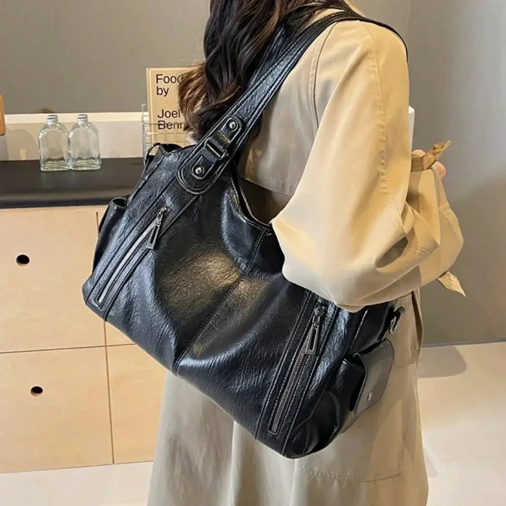 Soft interior compartment shoulder bag in black PU leather with silver zippers