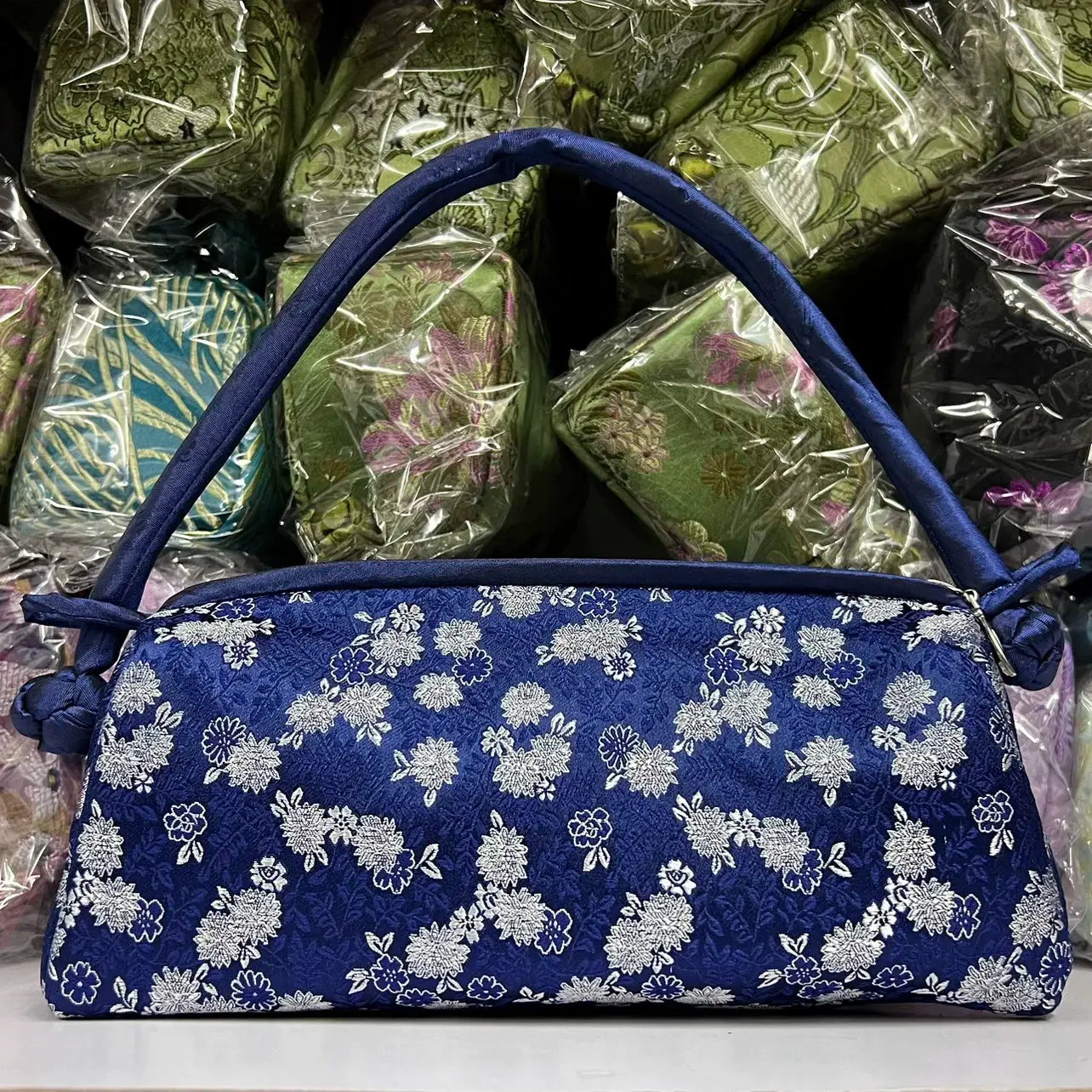 Blue embroidered satin shoulder bag for women with white floral motifs