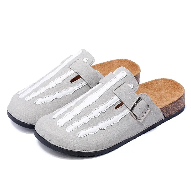 Pair of gray suede cork-footbed clogs with buckle strap and white wavy stitching; arch-support mules