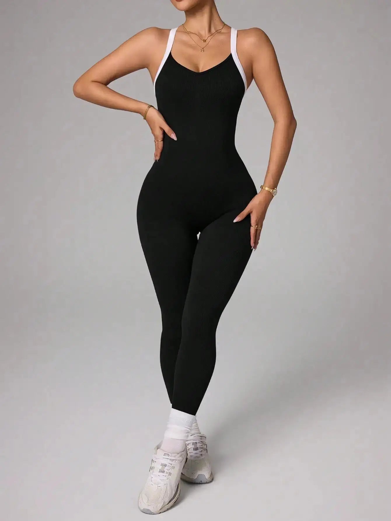 Cross-shoulder black jumpsuit with white straps for yoga and fitness
