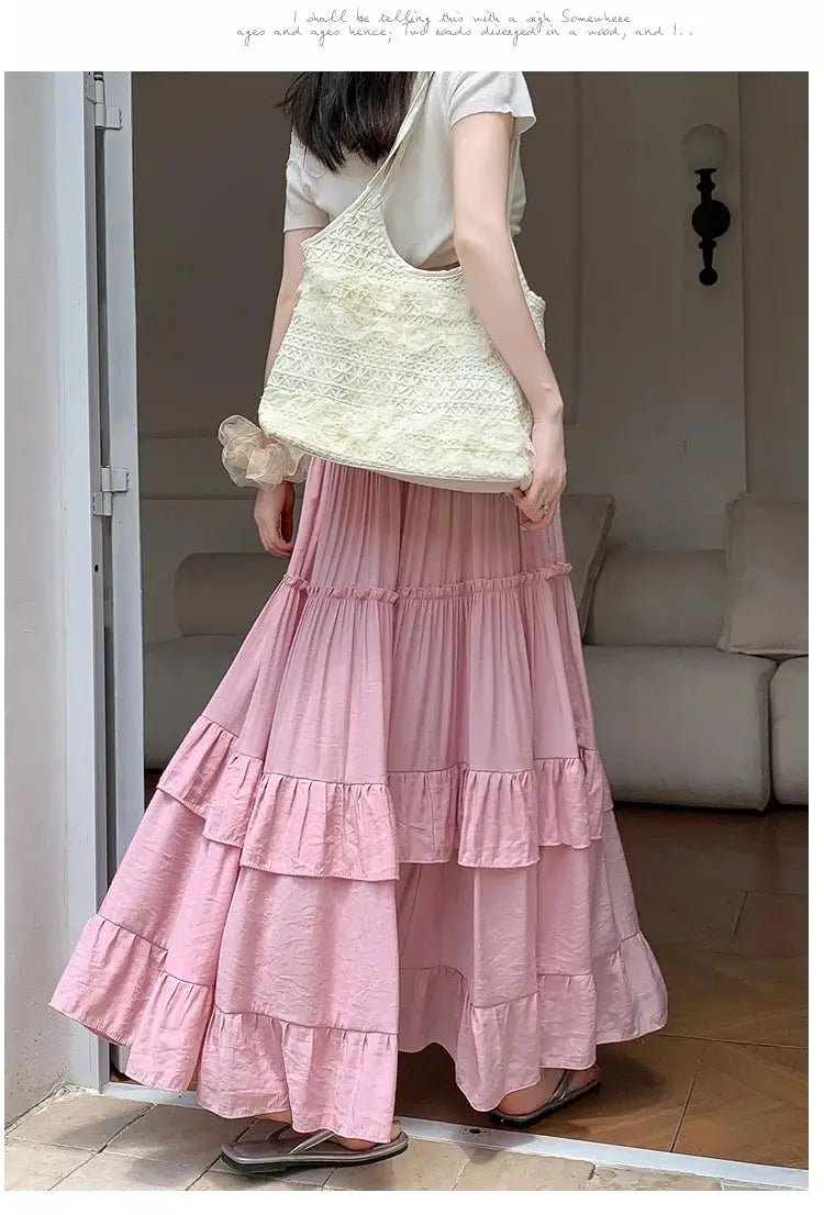 Pink tiered maxi skirt with ruffle layers and a flowy silhouette