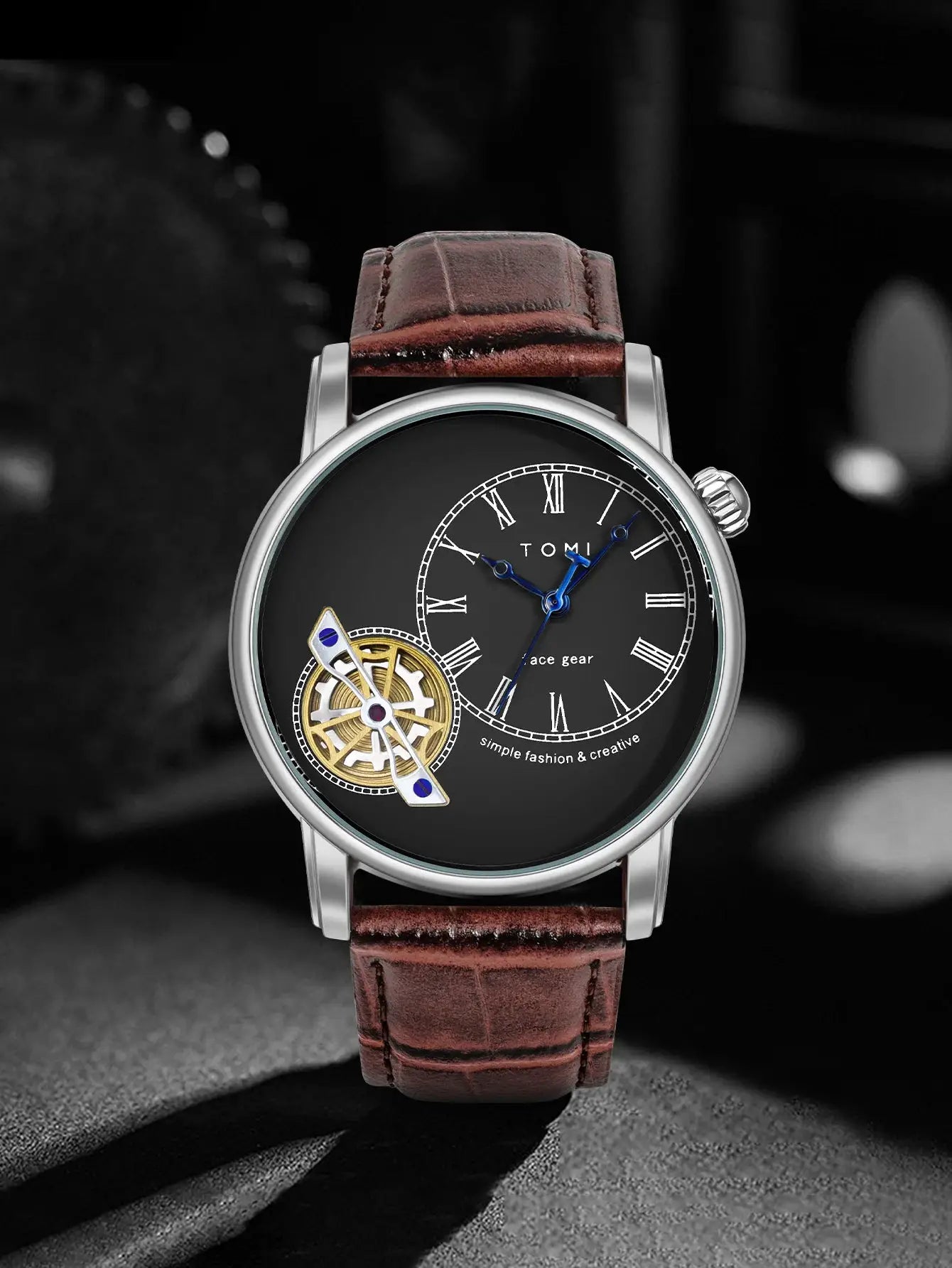 TOMI men's quartz watch with brown leather strap, black dial, Roman numerals and blue hands.