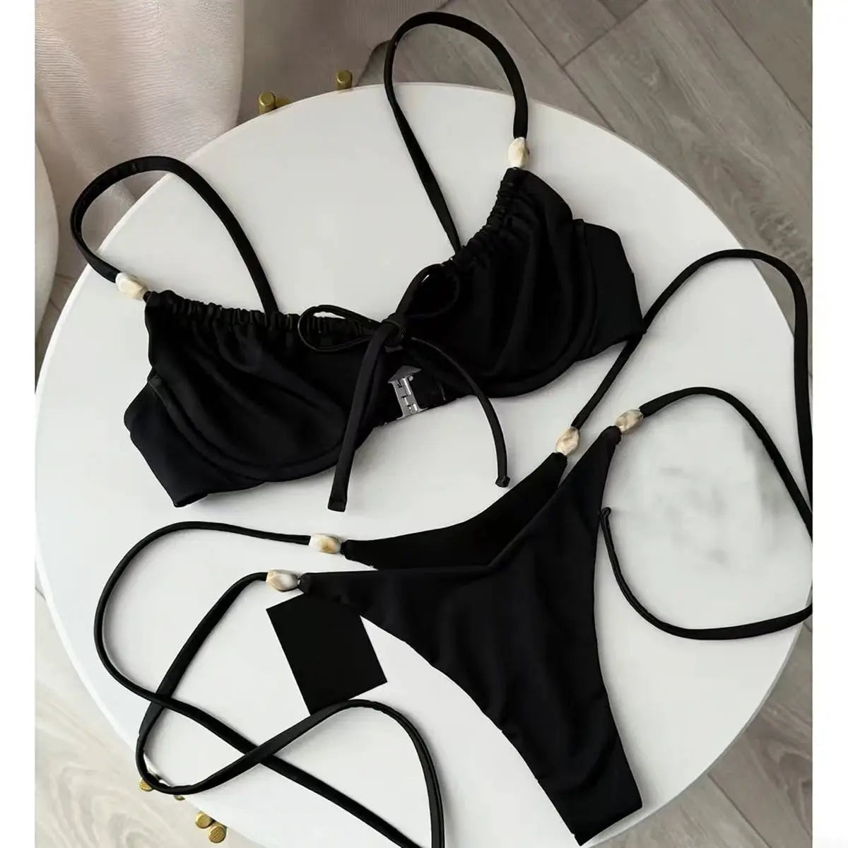 Black push-up bikini set with bead-embellished straps, triangle top and string bottoms