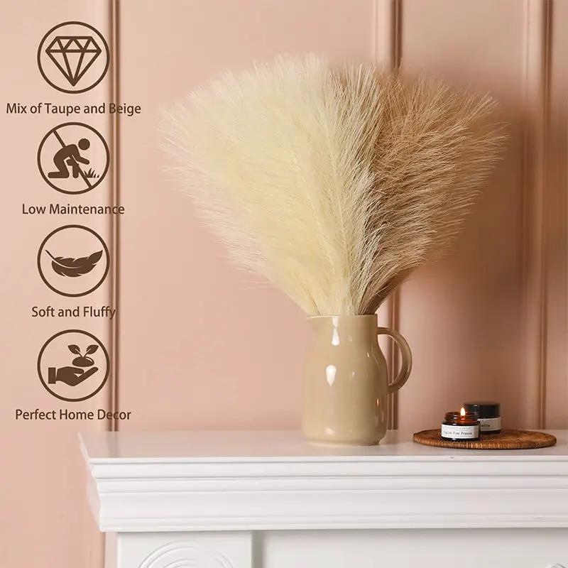 Artificial pampas grass bouquet in a beige vase with taupe and cream fluffy stems for boho party and wedding decor.