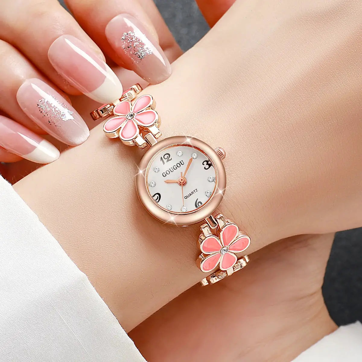 Women's rose-gold bracelet watch with pink flower links, crystal hour markers, white Arabic-numeral dial by Simples Market