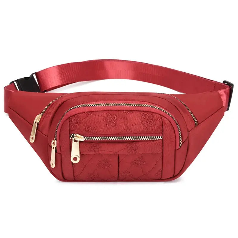Women's red Oxford waist bag with gold-tone zippers and multiple compartments