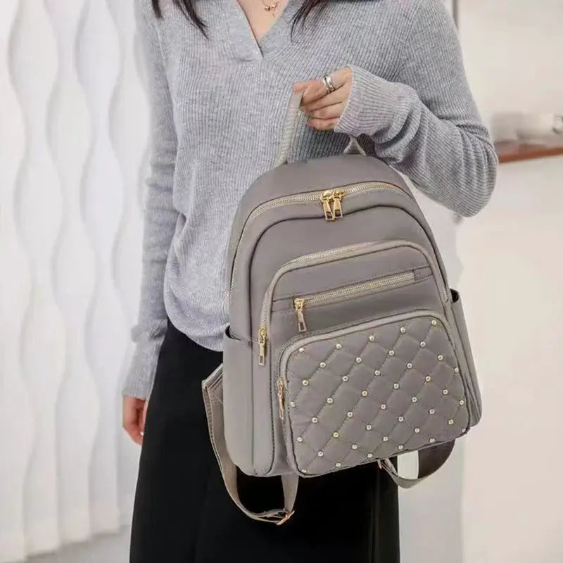 Simples Market gray travel backpack; large-capacity double-shoulder bag with quilted studded front pocket and gold zips