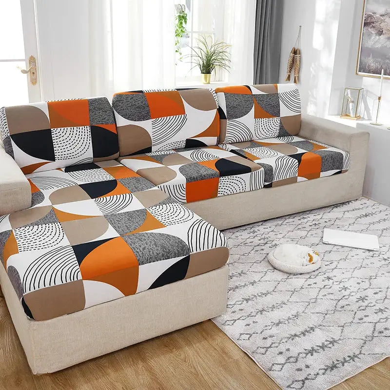 Elastic sofa slipcover by Simples Market in orange, beige and brown geometric pattern; washable and removable.