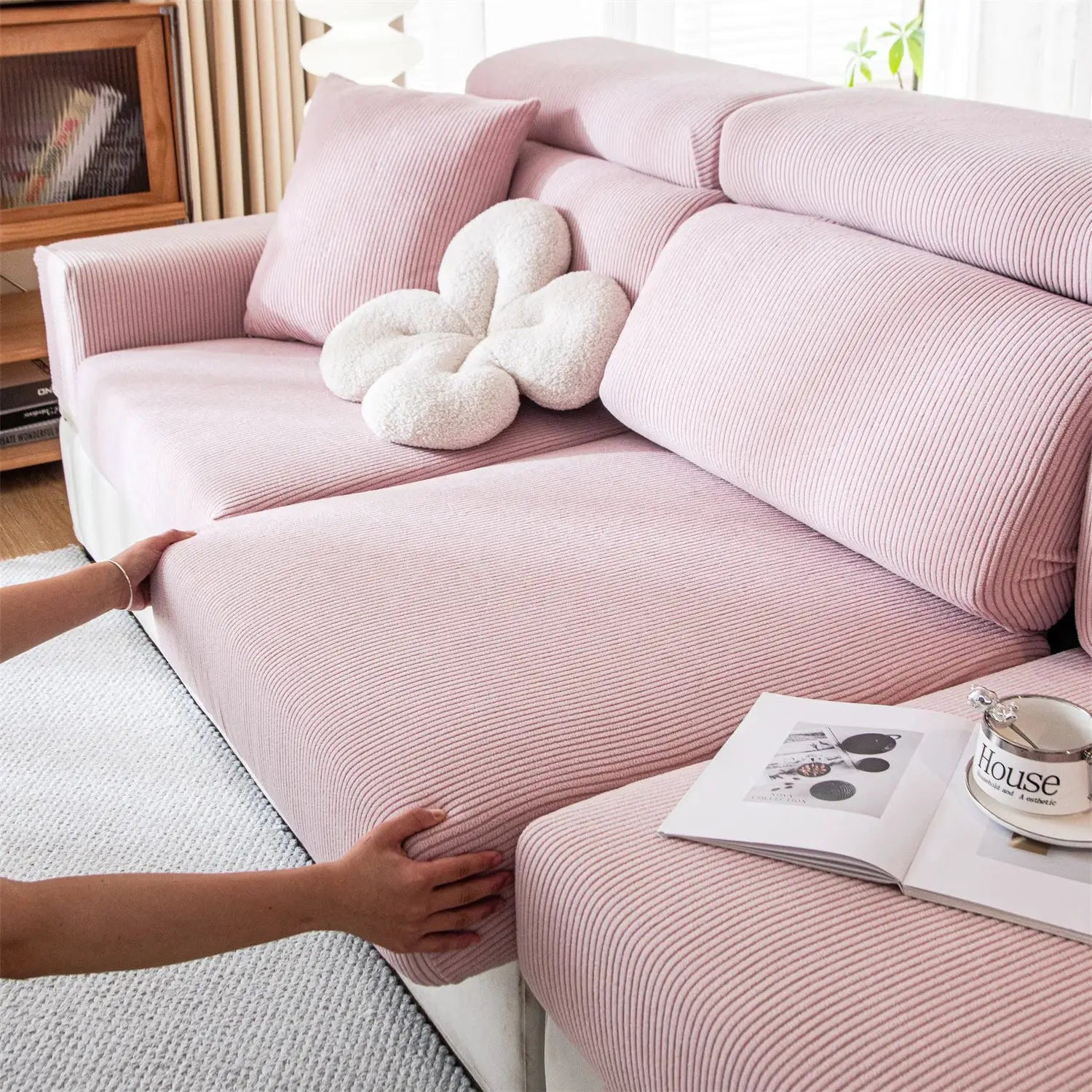 Pink striped jacquard sofa seat cushion cover, removable and stretchy, on a living room sofa