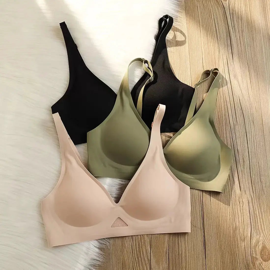 Four seamless padded push-up bralettes in nude, olive, and black; wireless, V-neck, breathable.