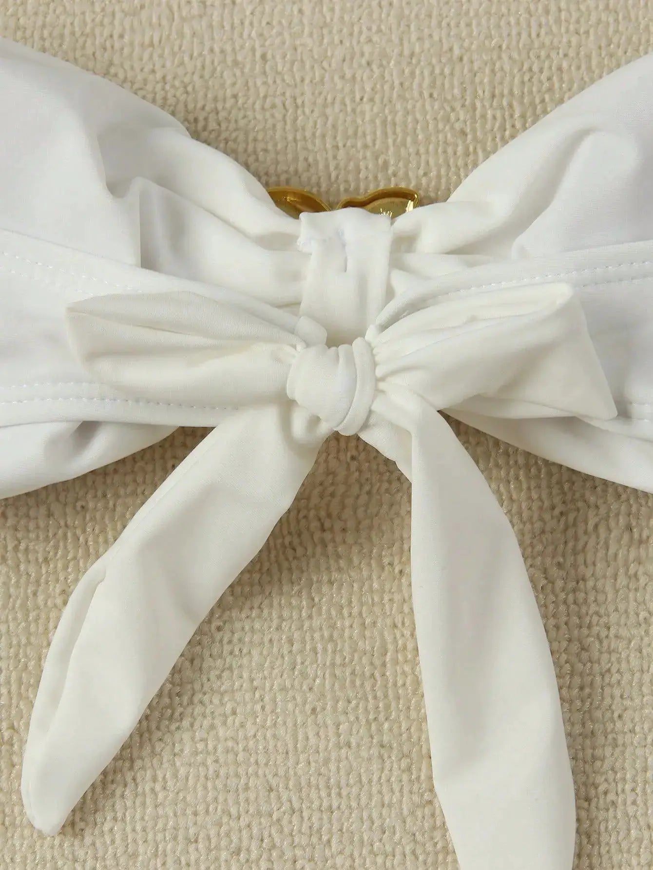 White bandeau bikini top with center bow knot and gold clasp detail