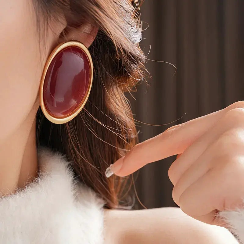 Vintage red resin oval stud earrings with gold-tone bezel