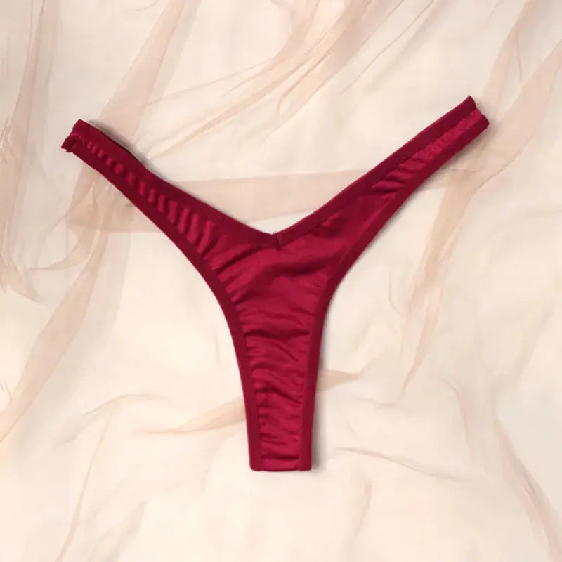 Red low-rise thong underwear with thin straps and silky fabric