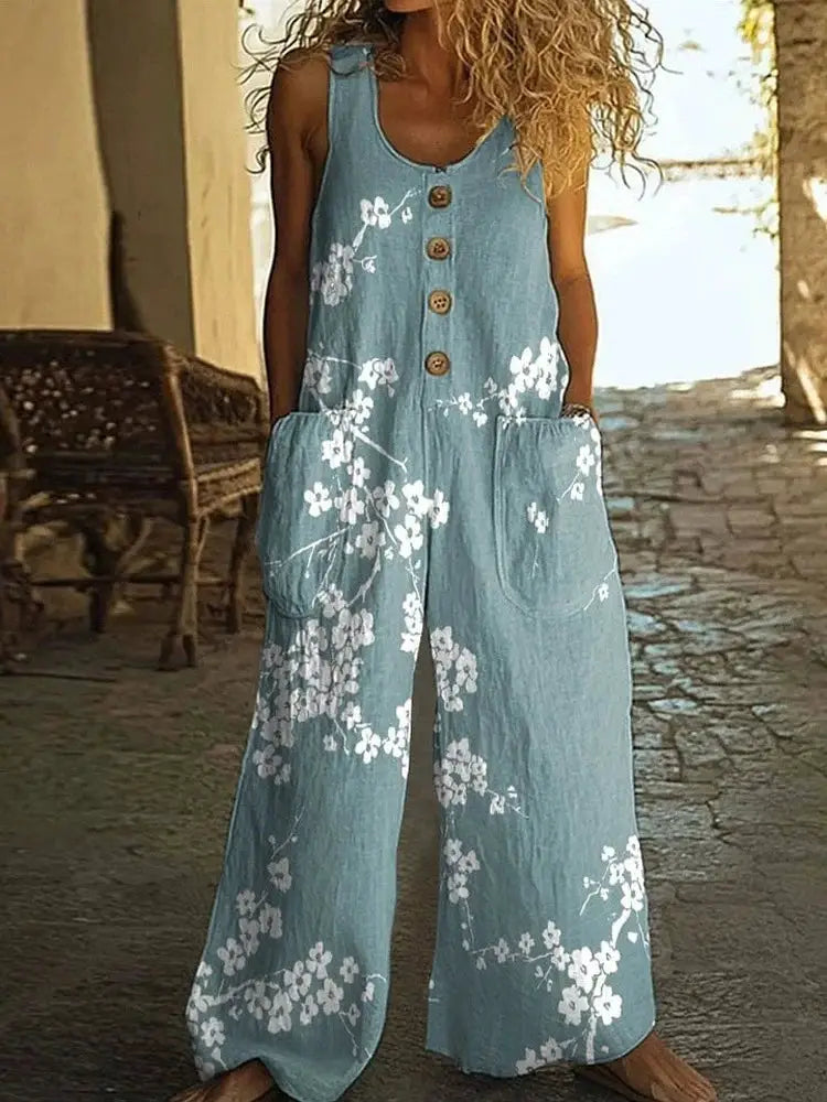 Jumpsuit, blue denim-style with white floral print, sleeveless with front button closure