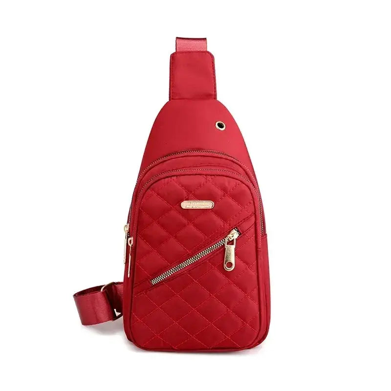Red quilted crossbody sling bag by Simples Market with gold-tone zippers
