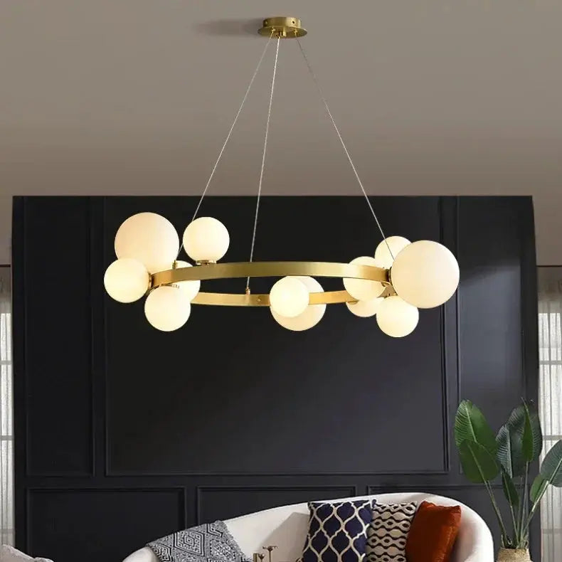 Simples Market brass ring chandelier with frosted globe bulbs; modern hanging pendant for living room