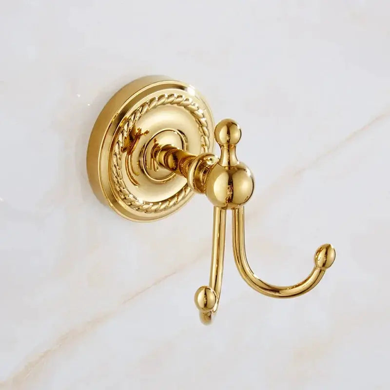 Robe hook in luxury gold brass with ornate round backplate.
