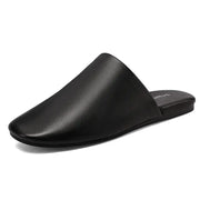 Simples Market black leather women's closed-toe mule slippers with flat sole.