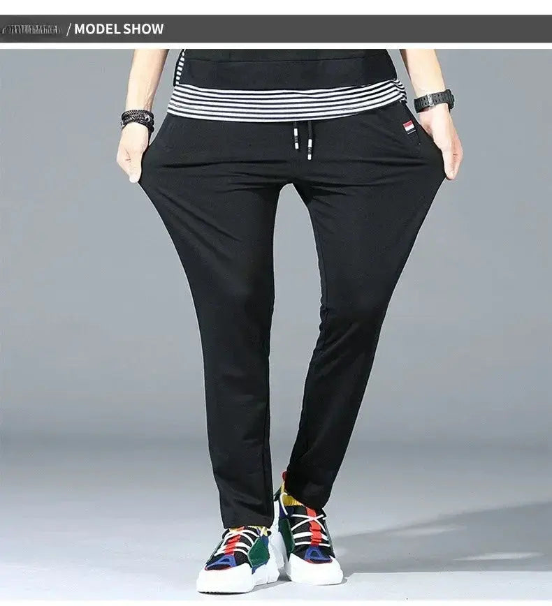 Men's black cotton jogger track pants with elastic waist and drawstring; loose-fit gym wear