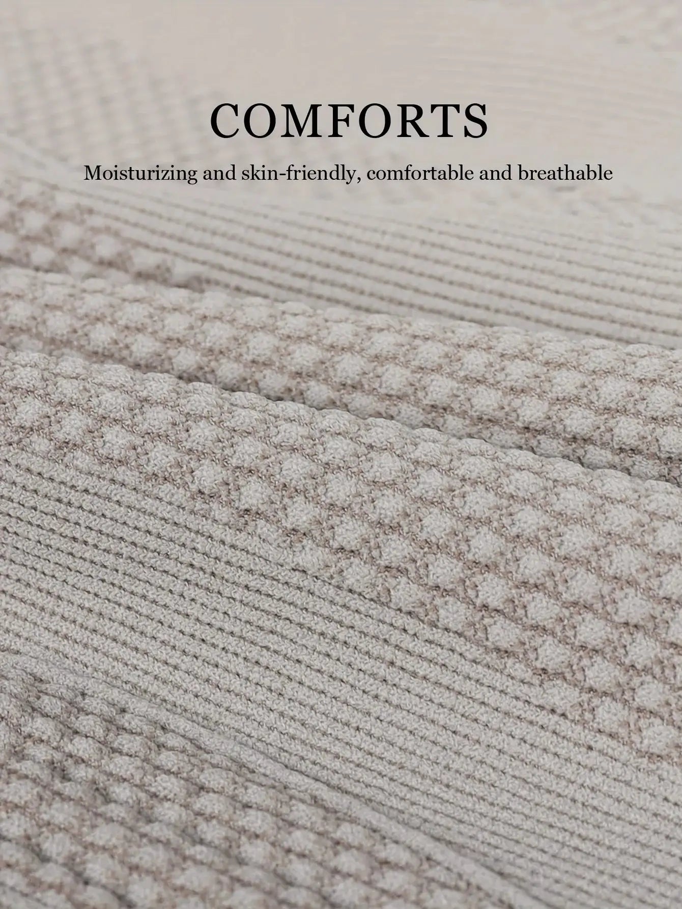 Beige towel fabric close-up with soft plush texture and ribbed pattern.