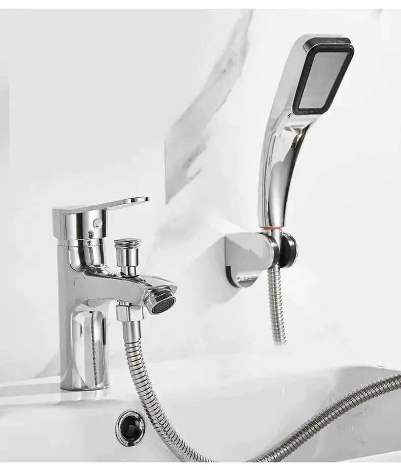 Chrome two-piece bathroom basin faucet with handheld shower and flexible hose, wall-mounted.