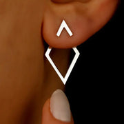 Geometric earrings with a small triangular stud and a larger hollow diamond-shaped square in silver-tone metal