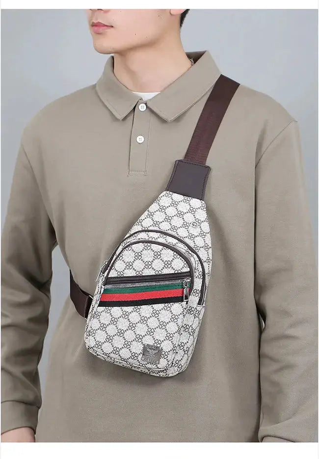 Men's crossbody messenger bag with patterned fabric and brown strap, front pocket and green-red-green stripe.