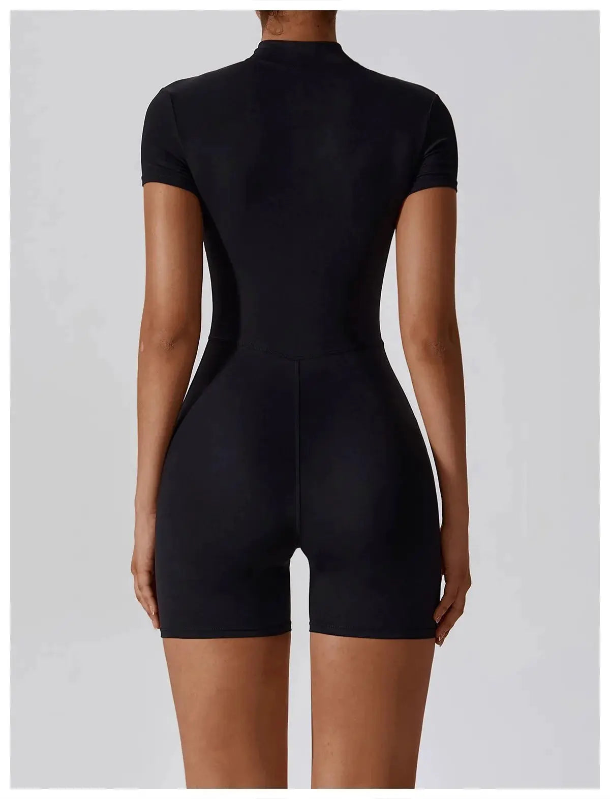 Women's black zipper short-sleeve yoga jumpsuit, back view, form-fitting fitness onesie.