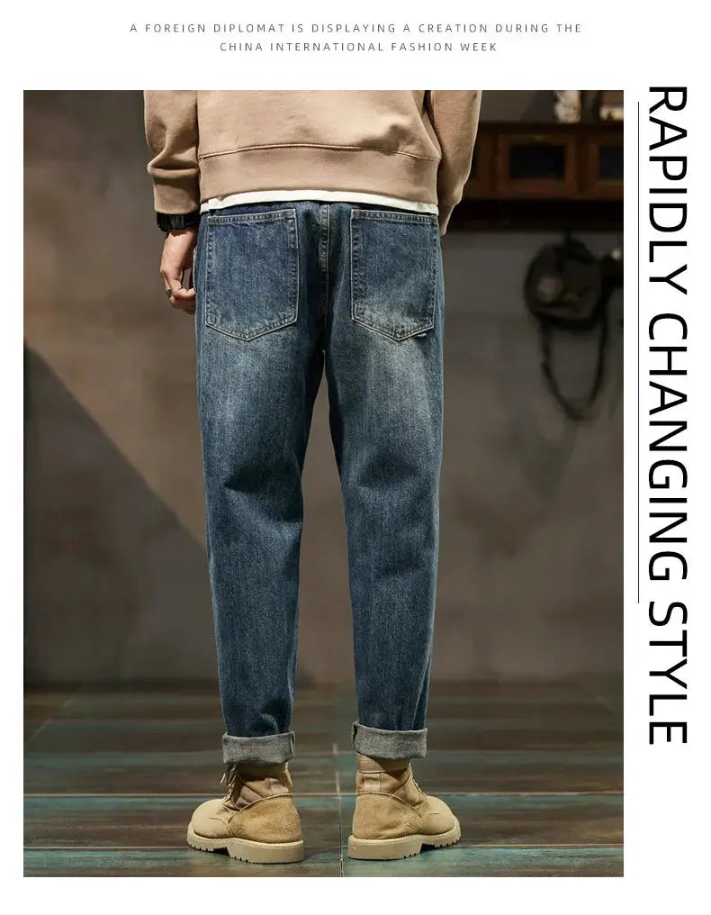 Men's blue denim jeans with back pockets, loose straight-leg fit, cuffed hems