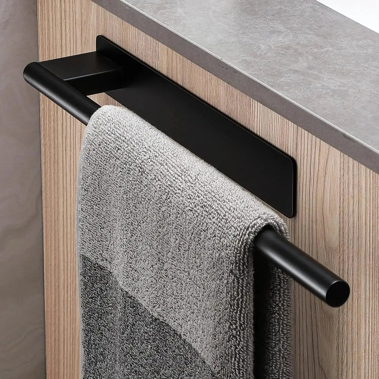 Towel bar by Simples Market; matte black stainless steel with no-drill adhesive mount.