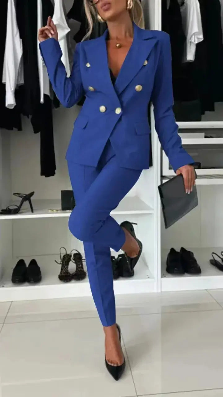 Blue women's 2-piece blazer and trousers suit by Simples Market with gold-tone buttons