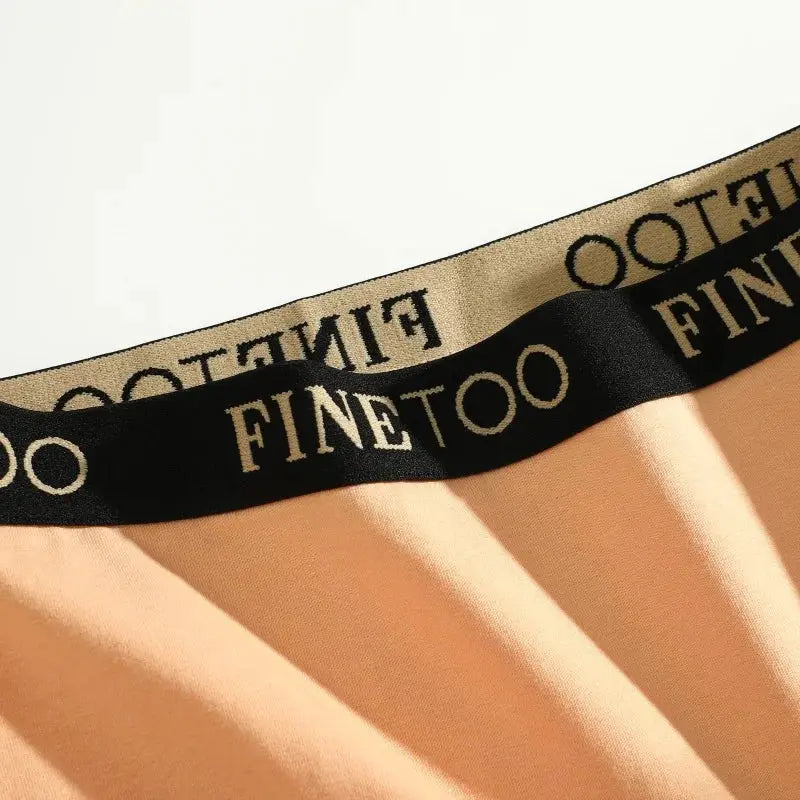 Finetoo peach seamless women's briefs with black elastic waistband featuring Finetoo logo