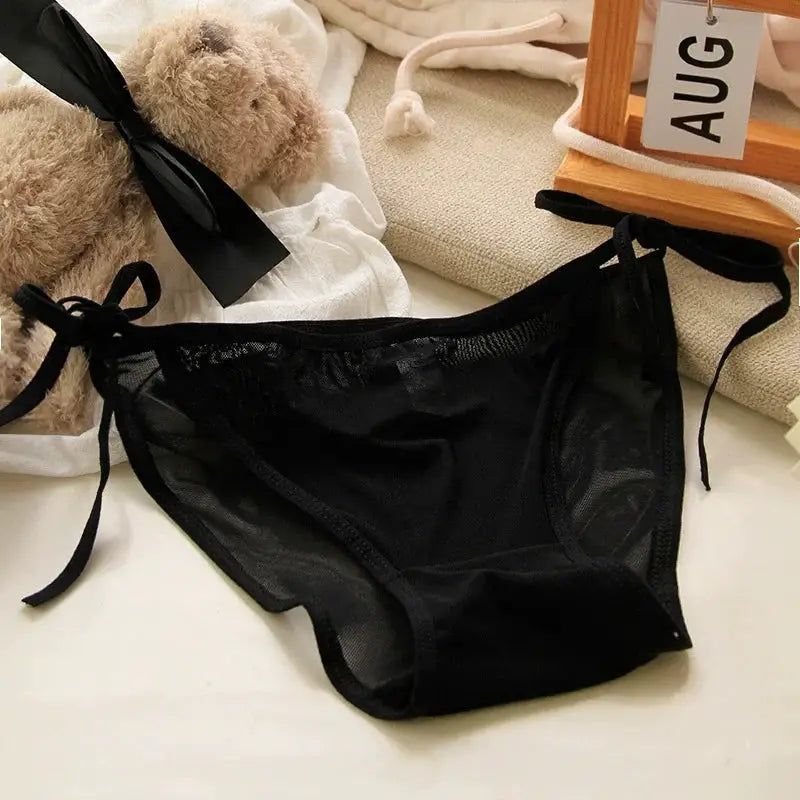 Lace-up black sheer briefs for women with side bows and a low waist