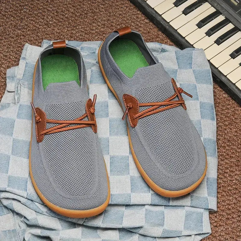 Barefoot shoes pair, unisex wide, gray knit upper, brown laces, green insoles, gum sole