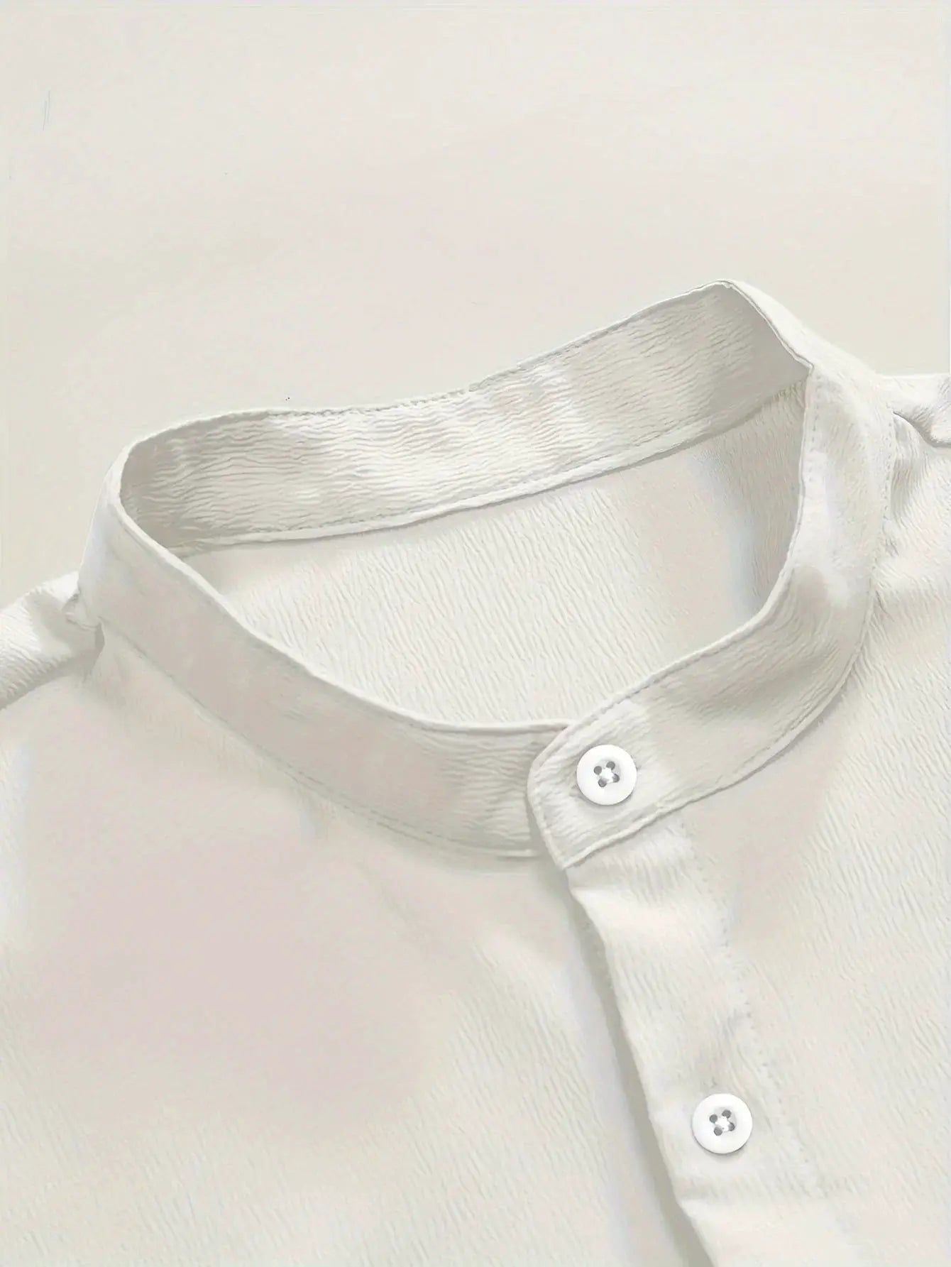 White solid-color linen short-sleeve shirt with stand-up collar and button placket