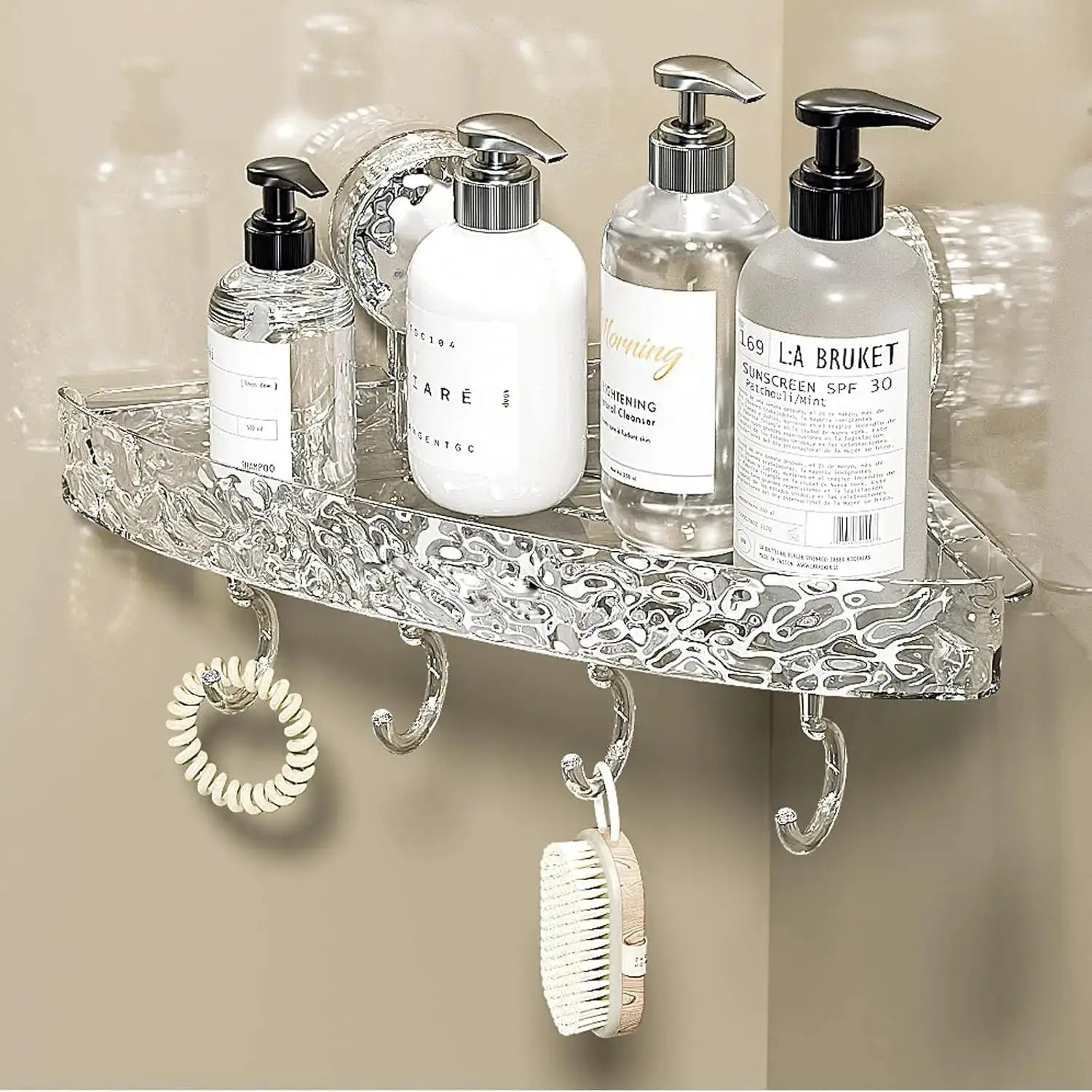 Corrugated suction cup storage shelf in glacier-patterned silver metal; four pump bottles sit on top with hanging hooks.