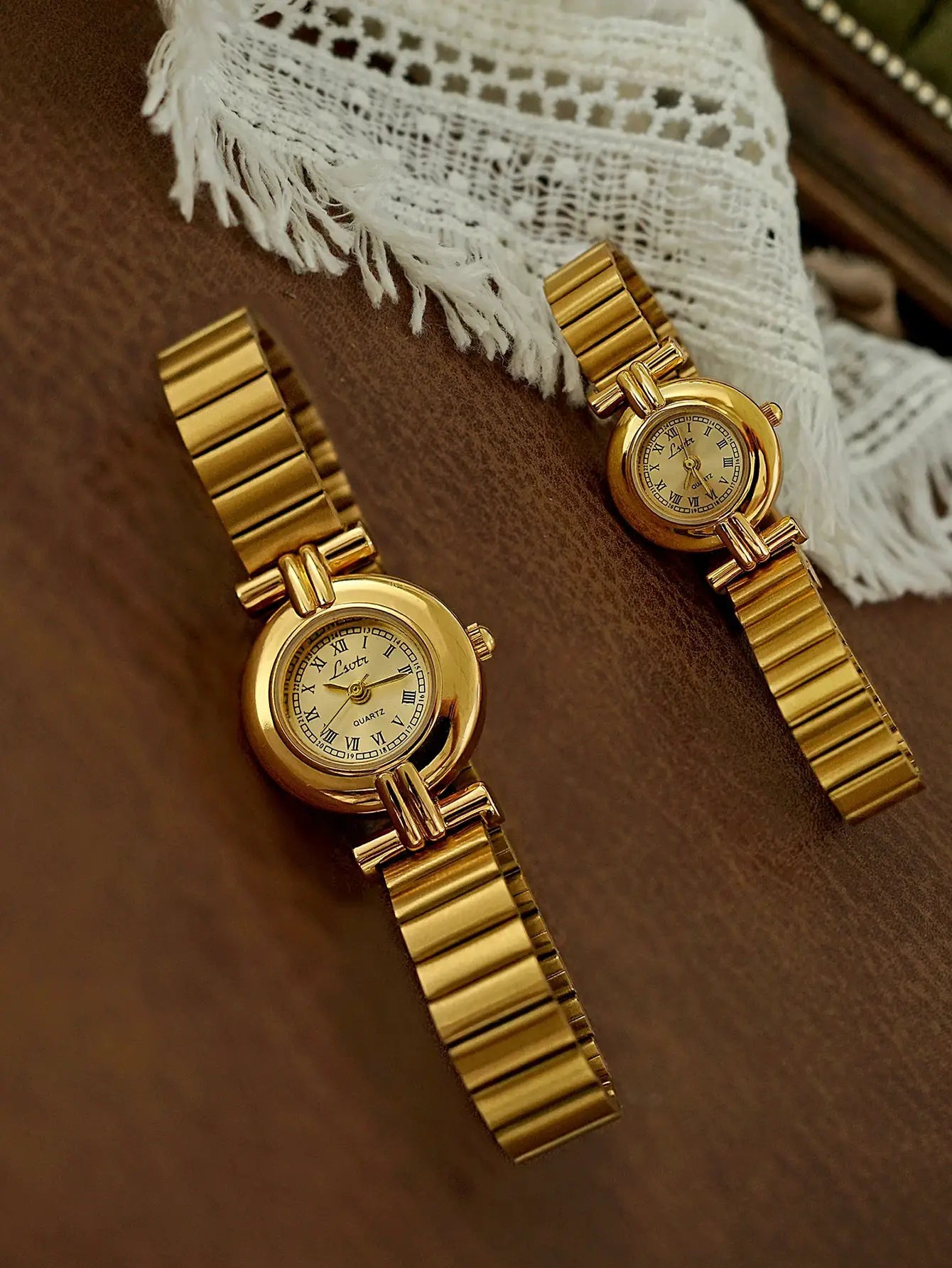 Two gold-tone French retro small-dial women's watches with Roman numerals and linked bracelets