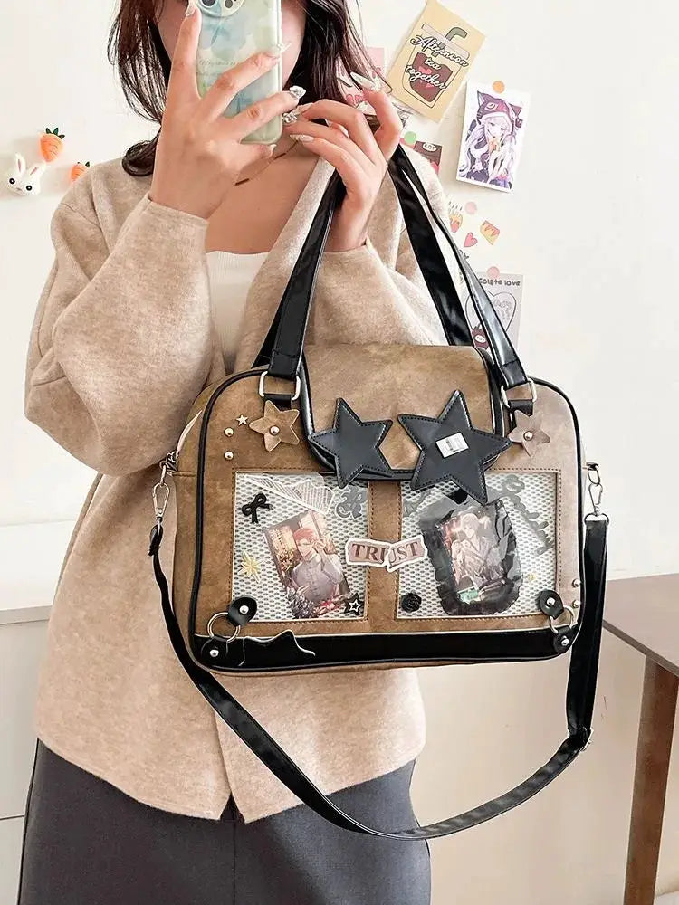 Ita bag in tan with clear front pocket showing photos, black star patches, and a crossbody strap.