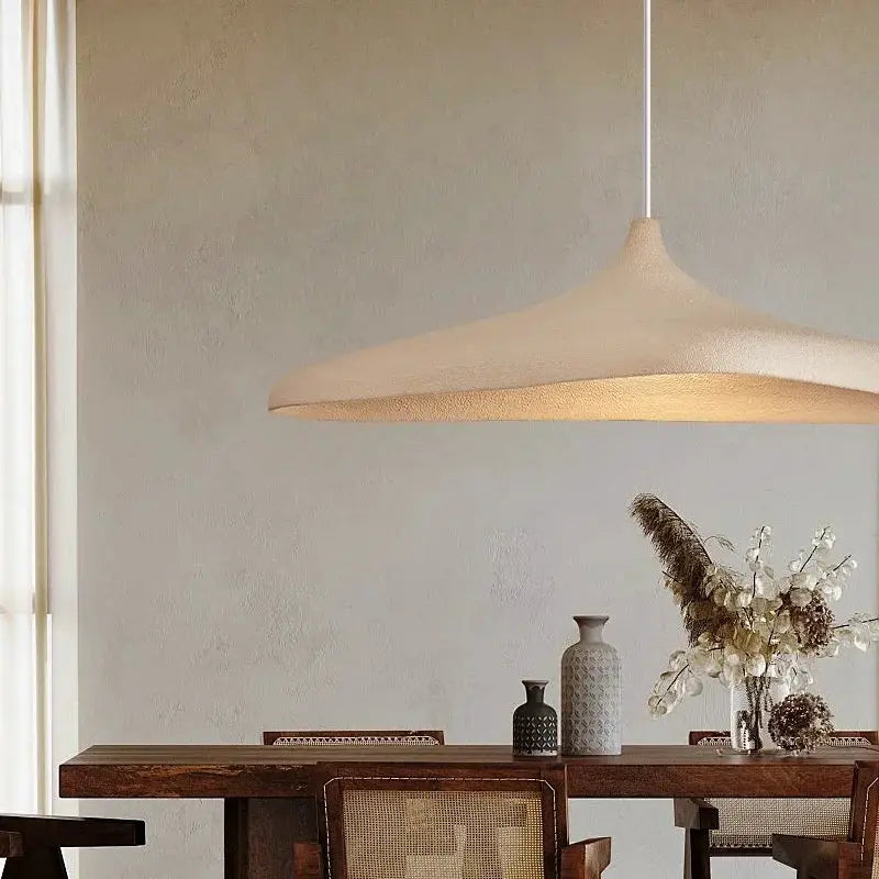 Japanese Wabi Sabi LED pendant light by Simples Market over dining table with cream curved shade