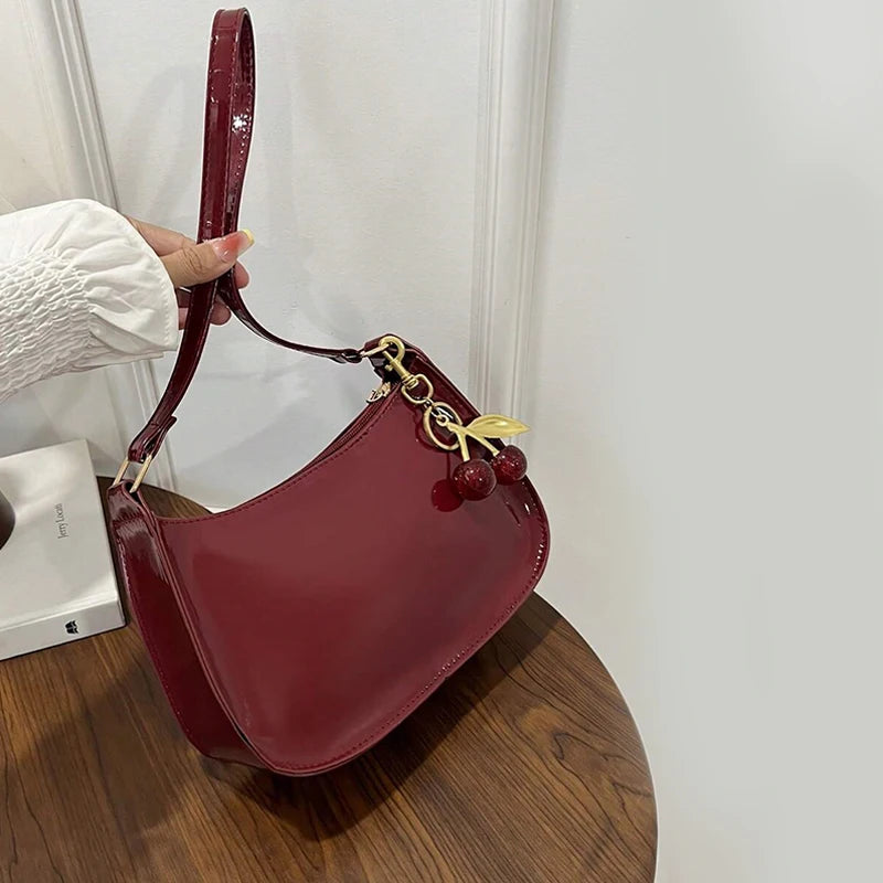 Women's PU leather handbag burgundy shoulder bag with cherry pendant charm and gold-tone hardware