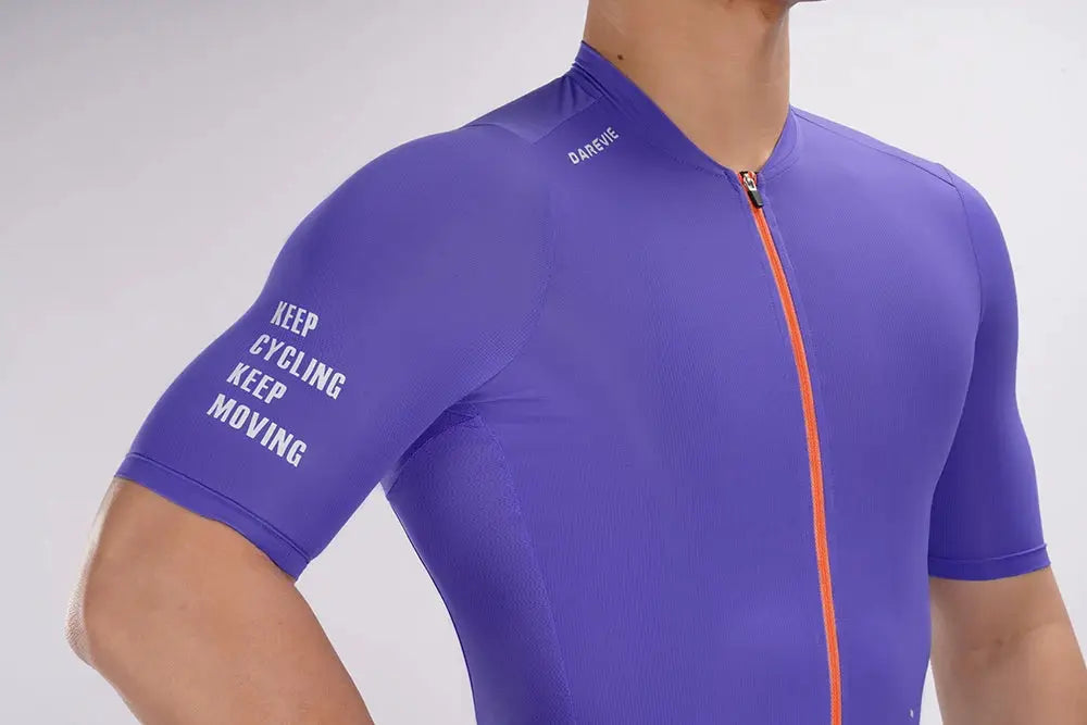 Cycling jersey purple with orange front zipper, short sleeves; DAREVIE branding and sleeve text, men's small size.