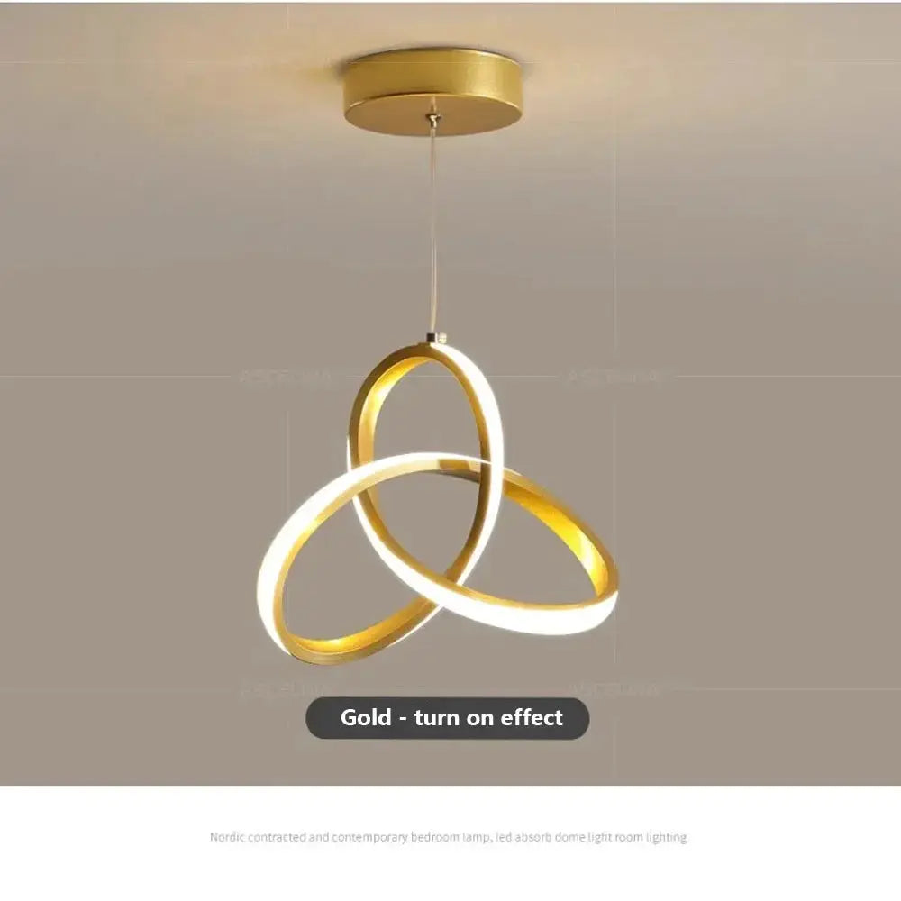 Nordic LED ceiling pendant lamp by Simples Market, gold three-ring intertwined design.
