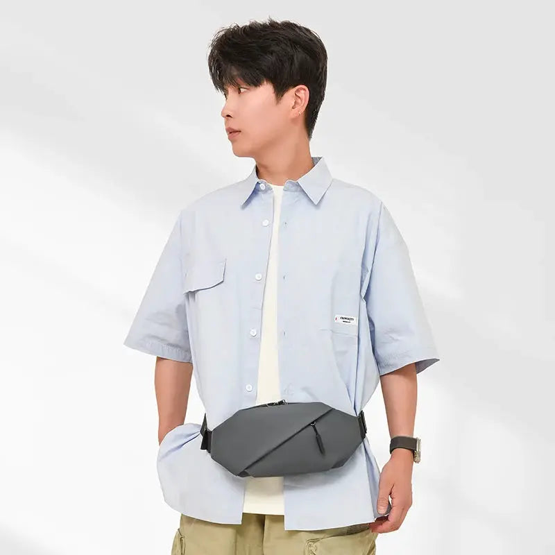 Men's grey minimalist outdoor waist bag for running, waterproof crossbody fanny pack.