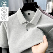 Men's light gray cotton polo shirt on hanger; breathable, sweat-absorbent fabric with polo collar and two-button placket