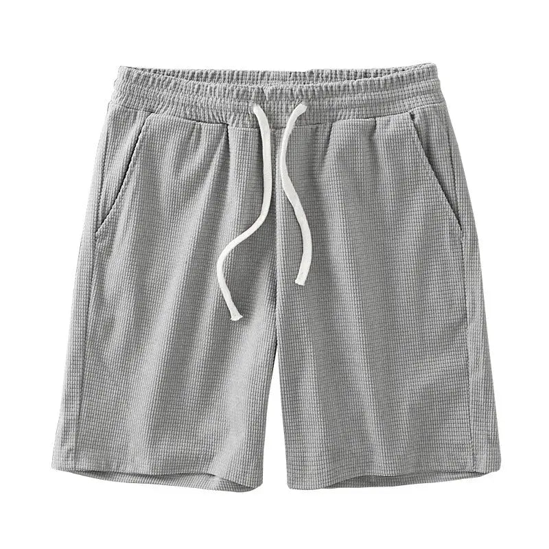 Men's gray waffle-textured shorts with drawstring, mid-waist, knee-length, two front pockets, casual.